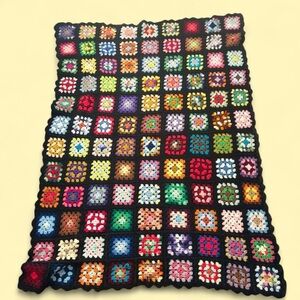 Handmade crocheted black and multicoloured rainbow granny square throw blanket